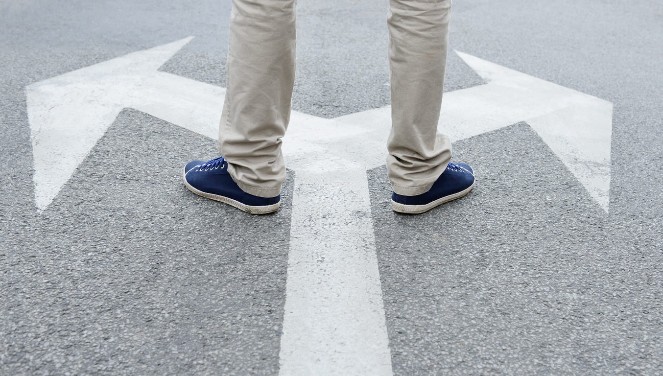 man standing on road to take decision