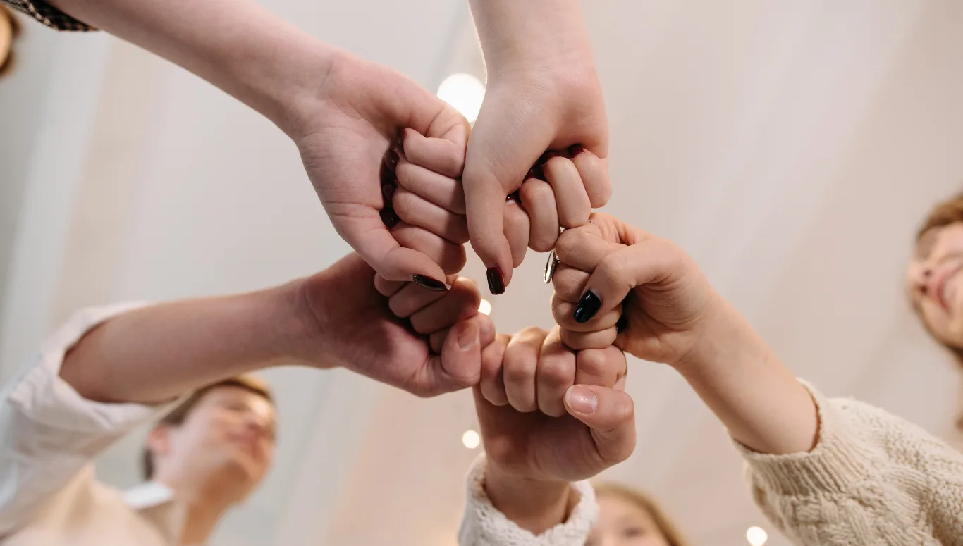 a group of people holding hands together